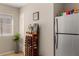 Cozy kitchen area with stainless steel refrigerator, wine rack and natural light from the window at 91 Rumson Ne Rd # C34, Atlanta, GA 30305