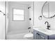Modern bathroom features white tile, black fixtures, and a stylish vanity at 994 Byron Sw Dr, Atlanta, GA 30310