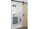 Stylish bathroom with a modern vanity, round mirror, and barn door entrance, offering a sleek design at 994 Byron Sw Dr, Atlanta, GA 30310