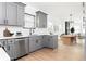 Modern kitchen featuring stainless steel appliances, sleek countertops, and an open layout to the dining area at 994 Byron Sw Dr, Atlanta, GA 30310