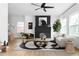 Bright living room featuring modern furniture, a black brick fireplace, and ample natural light at 994 Byron Sw Dr, Atlanta, GA 30310