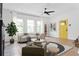 Spacious living room showcasing a bright yellow front door, modern decor, and abundant natural light at 994 Byron Sw Dr, Atlanta, GA 30310