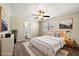 Staged bedroom with serene colors, soft bedding, and a ceiling fan at 1175 Jamestowne Trl, Alpharetta, GA 30009