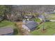 Aerial view of the house with a large backyard, including a storage shed, fire pit, and lush green grass at 2880 Hall Se Dr, Smyrna, GA 30082