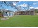 Expansive backyard with a shed, fire pit, and covered patio, ideal for outdoor activities and gatherings at 2880 Hall Se Dr, Smyrna, GA 30082