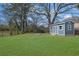 A spacious, green backyard features a storage shed and a fire pit perfect for outdoor relaxation at 2880 Hall Se Dr, Smyrna, GA 30082