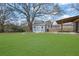 Green backyard featuring a storage shed, patio, and a fire pit perfect for outdoor living and entertainment at 2880 Hall Se Dr, Smyrna, GA 30082
