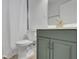 This bathroom features a toilet and blue vanity with gold hardware, offering a clean and modern aesthetic at 2880 Hall Se Dr, Smyrna, GA 30082