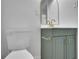 Bathroom featuring a toilet, modern gold mirror, and a green vanity at 2880 Hall Se Dr, Smyrna, GA 30082