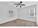 Bright bedroom features neutral carpet, ceiling fan, and two windows allowing for lots of natural light at 2880 Hall Se Dr, Smyrna, GA 30082