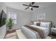 Staged bedroom featuring a ceiling fan, new carpet, and a plant for natural colors at 2880 Hall Se Dr, Smyrna, GA 30082