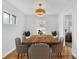 Staged dining room featuring hardwood floors, table with chairs, and modern light fixture at 2880 Hall Se Dr, Smyrna, GA 30082