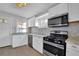 Modern kitchen featuring white cabinetry, stainless steel appliances, and mosaic tile backsplash at 2880 Hall Se Dr, Smyrna, GA 30082