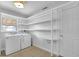 Laundry room featuring a washer, dryer, built in shelves and a window for natural light at 2880 Hall Se Dr, Smyrna, GA 30082