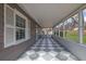 View of the long screened-in porch with a black and white checkered floor at 2880 Hall Se Dr, Smyrna, GA 30082