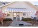 Cozy outdoor space featuring a striped awning covering the patio, with manicured shrubs at 312 Overview Dr, Canton, GA 30114