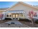 A quaint backyard with a striped awning, well-maintained landscaping, and a stone pathway at 312 Overview Dr, Canton, GA 30114