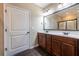 Bathroom featuring double sink vanity with wood cabinets and large mirror at 312 Overview Dr, Canton, GA 30114