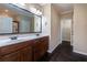 Bathroom featuring double sink vanity, dark wood cabinets and a walk-in closet at 312 Overview Dr, Canton, GA 30114