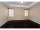 Spacious bedroom with dark wood floors, neutral walls, and white window shutters at 312 Overview Dr, Canton, GA 30114