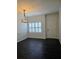 Elegant dining room featuring dark floors, white walls, and a modern light fixture at 312 Overview Dr, Canton, GA 30114