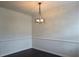 Elegant dining room featuring dark floors, white walls, and a modern light fixture at 312 Overview Dr, Canton, GA 30114