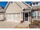 Charming home with a two-car garage, stone accents, and a welcoming front door at 312 Overview Dr, Canton, GA 30114