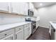 Modern kitchen featuring white cabinets, stainless steel appliances, and sleek countertops at 312 Overview Dr, Canton, GA 30114
