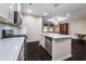 Bright kitchen features white cabinets, stainless steel appliances, and a center island with quartz countertops at 312 Overview Dr, Canton, GA 30114