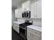 The kitchen showcases modern stainless steel appliances and white countertops at 312 Overview Dr, Canton, GA 30114