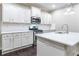 Well-lit kitchen with white cabinetry, stainless steel appliances, and a large center island with a sink at 312 Overview Dr, Canton, GA 30114
