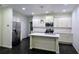 Modern kitchen with white cabinets, stainless steel appliances, and a center island at 312 Overview Dr, Canton, GA 30114