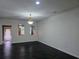 Bright and airy living room with neutral walls, dark floors, and natural light from windows and a glass door at 312 Overview Dr, Canton, GA 30114