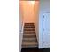 Carpeted staircase leads to the upper level of the home at 312 Overview Dr, Canton, GA 30114