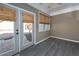 Bright sunroom with neutral walls, tile flooring, and French doors leading to a patio at 312 Overview Dr, Canton, GA 30114