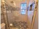 Bathroom featuring glass enclosed shower with stylish tile and modern fixtures at 505 Tilbury Dr, Suwanee, GA 30024