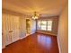 Bedroom with hardwood floors, double closet, and view of an en-suite bathroom at 505 Tilbury Dr, Suwanee, GA 30024