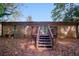 Spacious brick home backyard featuring a wooden deck and lush autumn foliage at 5411 Louis Xiv Ln, Atlanta, GA 30349