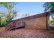 Backyard features a wooden deck, brick exterior, and tree-lined perimeter at 5411 Louis Xiv Ln, Atlanta, GA 30349