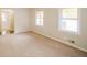 Cozy living room featuring neutral carpet, ample natural light from bright double windows at 5411 Louis Xiv Ln, Atlanta, GA 30349