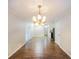 Bright dining room features hardwood floors and elegant chandelier at 5411 Louis Xiv Ln, Atlanta, GA 30349