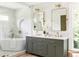 Bright bathroom featuring a soaking tub, a double vanity, and lots of natural light at 1563 Westwood Sw Ave, Atlanta, GA 30310