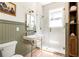 Bathroom featuring a vanity, a glass enclosed shower, and shiplap at 1563 Westwood Sw Ave, Atlanta, GA 30310