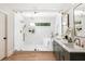 Elegant bathroom with glass shower, freestanding tub, and a double vanity at 1563 Westwood Sw Ave, Atlanta, GA 30310