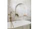 Close-up of elegant bathroom with a soaking tub and marble herringbone tile surround at 1563 Westwood Sw Ave, Atlanta, GA 30310