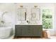 Elegant bathroom featuring a double vanity, soaking tub, and herringbone tile at 1563 Westwood Sw Ave, Atlanta, GA 30310