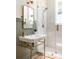 Charming bathroom features a classic console sink with gold fixtures and a glass-enclosed shower with tiled walls at 1563 Westwood Sw Ave, Atlanta, GA 30310