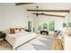 Bright bedroom boasts vaulted ceilings with dark ceiling fan and decorative wooden beams and hardwood floors at 1563 Westwood Sw Ave, Atlanta, GA 30310