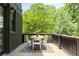 This inviting outdoor deck offers a cozy dining area with a wooden table and plenty of greenery at 1563 Westwood Sw Ave, Atlanta, GA 30310