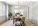 Bright dining room with white wainscoting, a wooden table with seating for six, and windows with outside views at 1563 Westwood Sw Ave, Atlanta, GA 30310